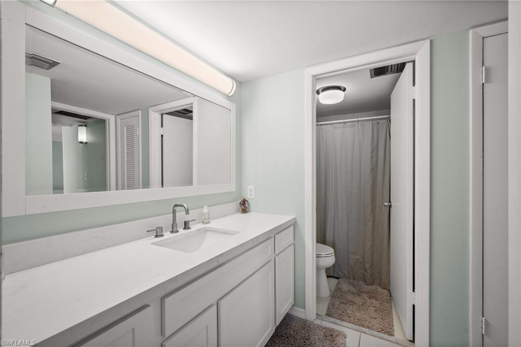 Undisclosed Address Naples, FL 34103 - Photo 11 of 24 a bathroom with a sink a toilet and shower