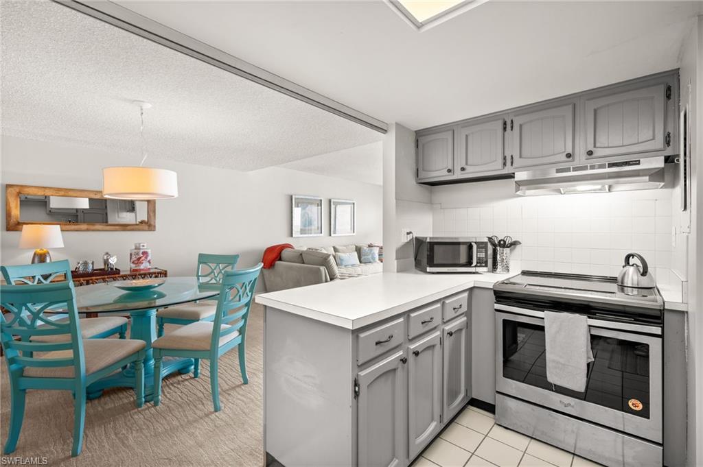 Undisclosed Address Naples, FL 34103 - Photo 24 of 24 a kitchen with a stove top oven cabinets and a refrigerator