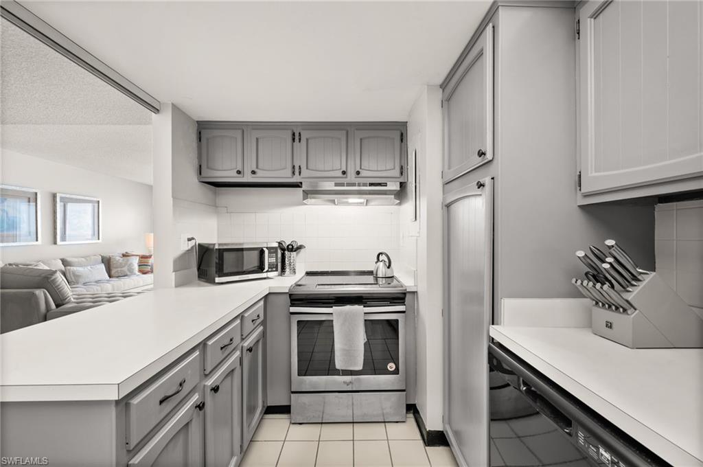 Undisclosed Address Naples, FL 34103 - Photo 5 of 24 a kitchen with a sink stove and refrigerator