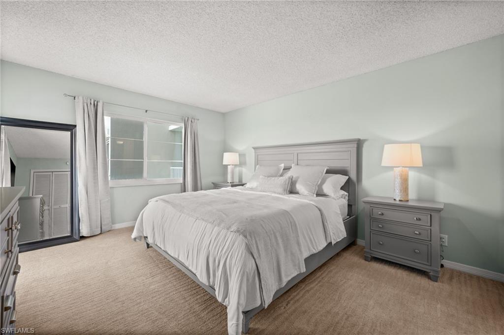Undisclosed Address Naples, FL 34103 - Photo 7 of 24 a spacious bedroom with a bed and a window