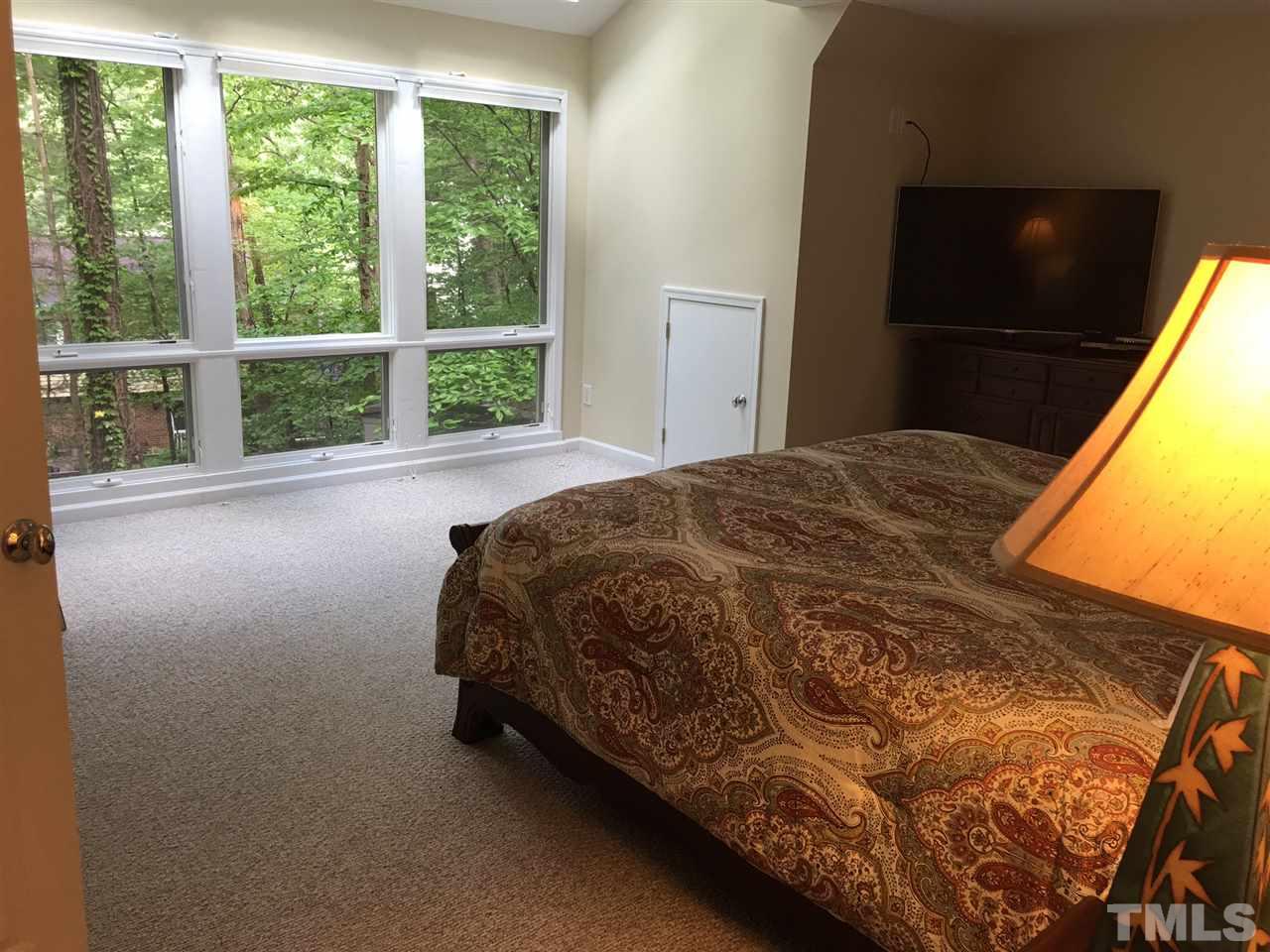 3300 Boulder Court Raleigh, NC 27607 - Photo 22 of 22 a bed sitting in a bedroom next to a window