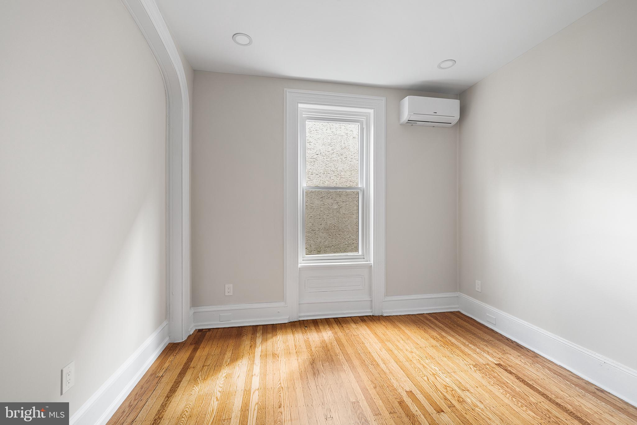2309 Green Street, Unit 2R Philadelphia, PA 19130 - Photo 4 of 15 a view of a room with wooden floor and window