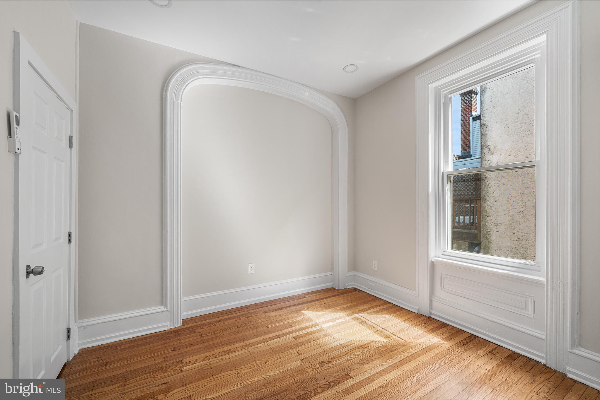 2309 Green Street, Unit 2R Philadelphia, PA 19130 - Photo 5 of 15 a view of empty room with wooden floor and fan