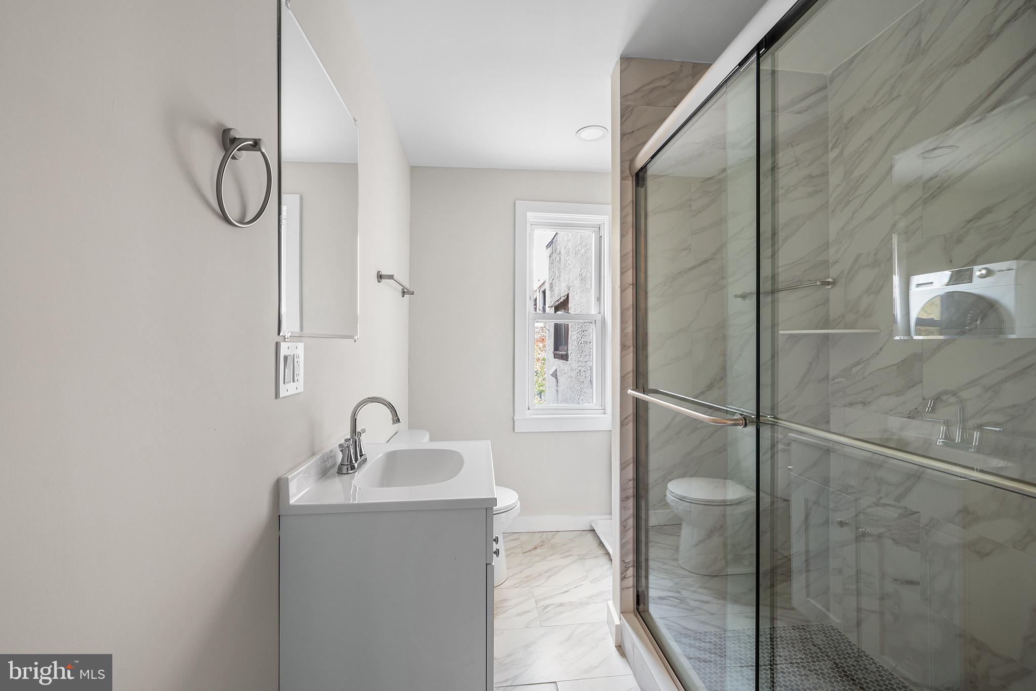2309 Green Street, Unit 2R Philadelphia, PA 19130 - Photo 6 of 15 a bathroom with a sink and glass door
