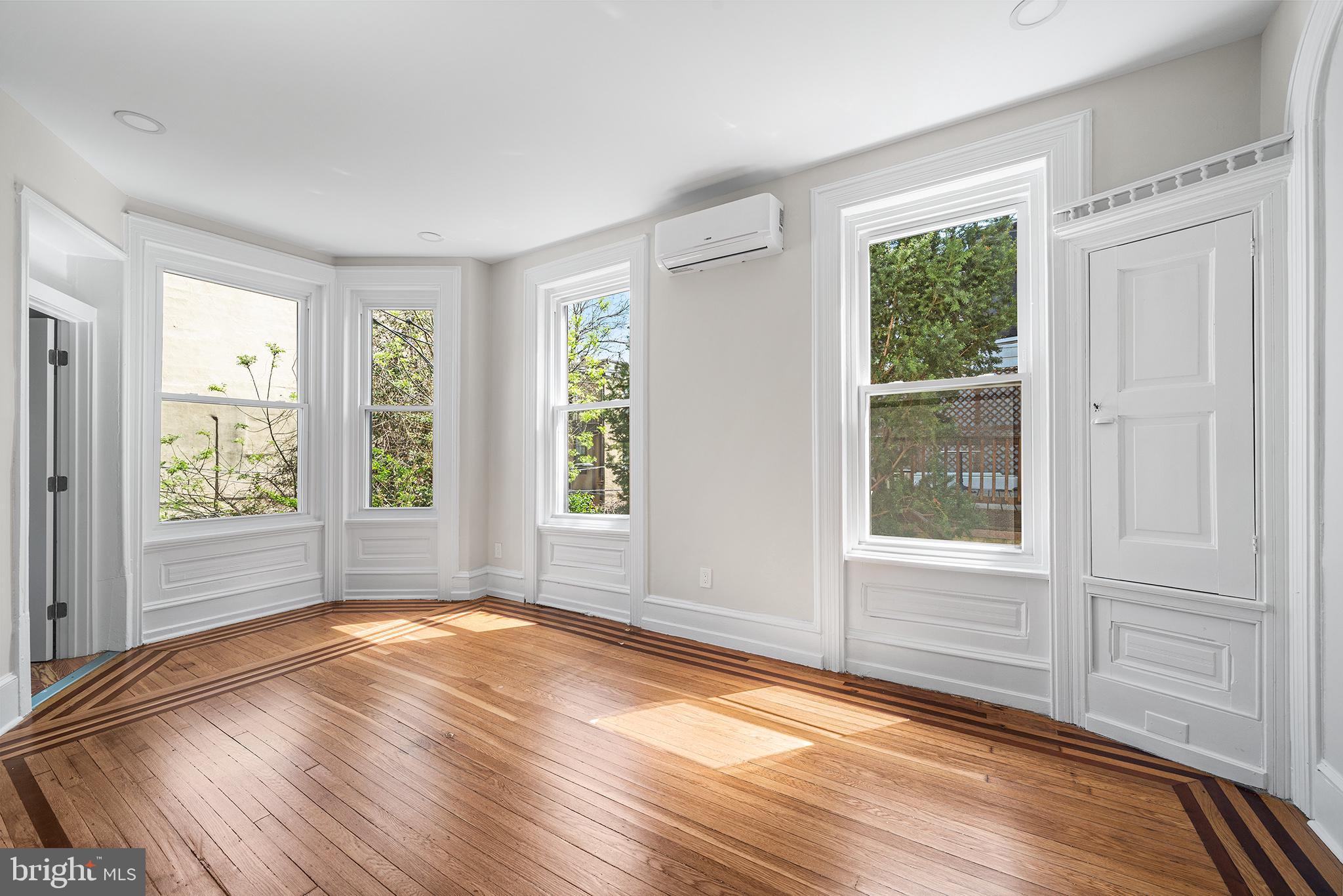 2309 Green Street, Unit 2R Philadelphia, PA 19130 - Photo 8 of 15 an empty room with wooden floor and windows