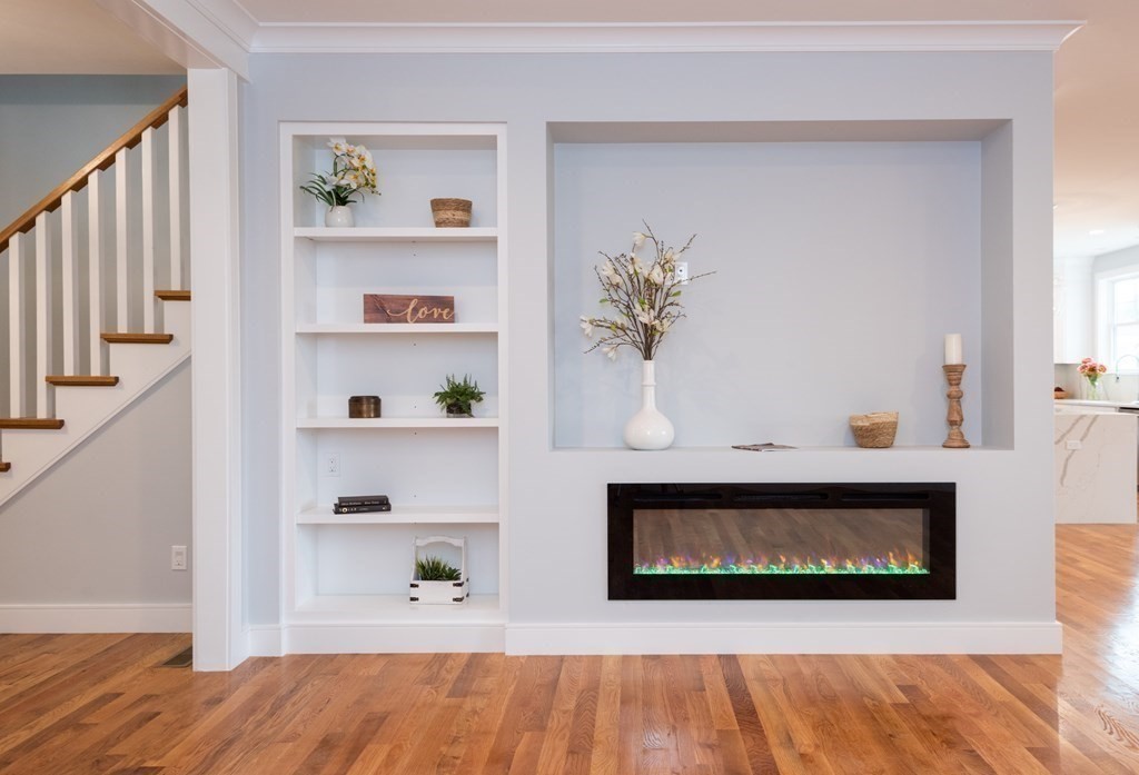 103 Francis Wyman Road Burlington, MA 01803 - Photo 14 of 42 a living room with a fireplace and wooden floor