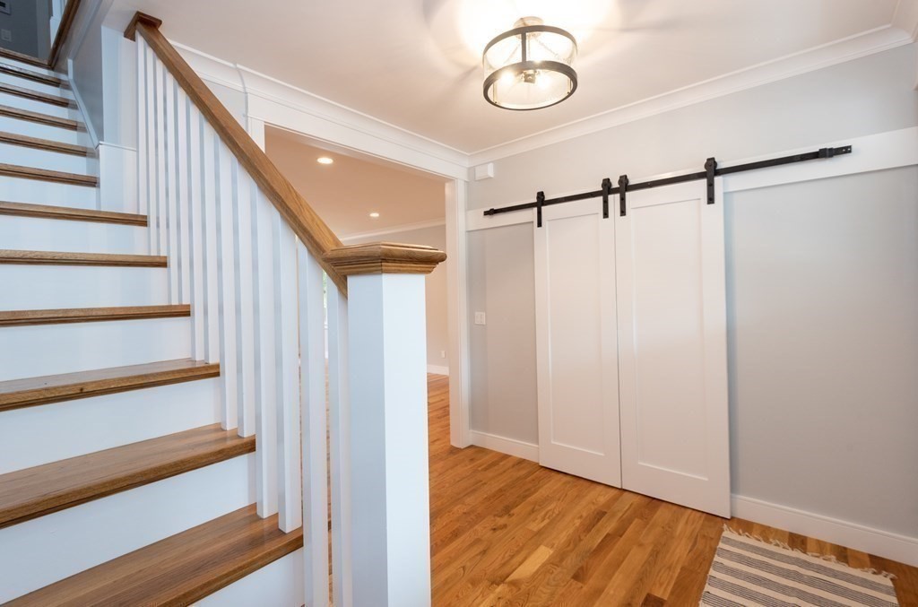 103 Francis Wyman Road Burlington, MA 01803 - Photo 21 of 42 a view of a hallway with wooden floor and staircase