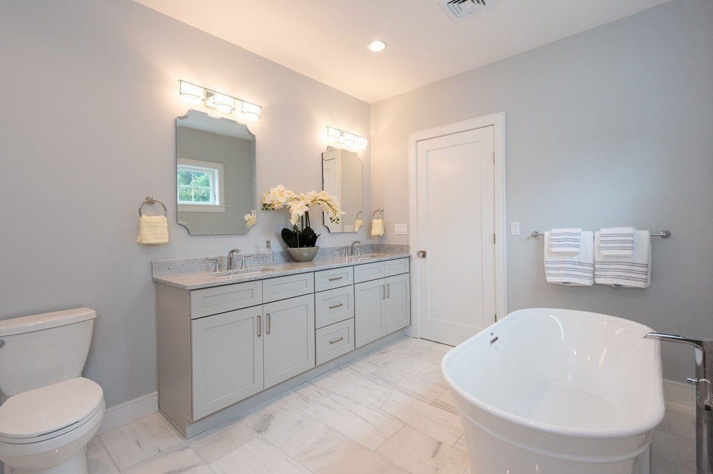 103 Francis Wyman Road Burlington, MA 01803 - Photo 25 of 42 a bathroom with a toilet sink and mirror