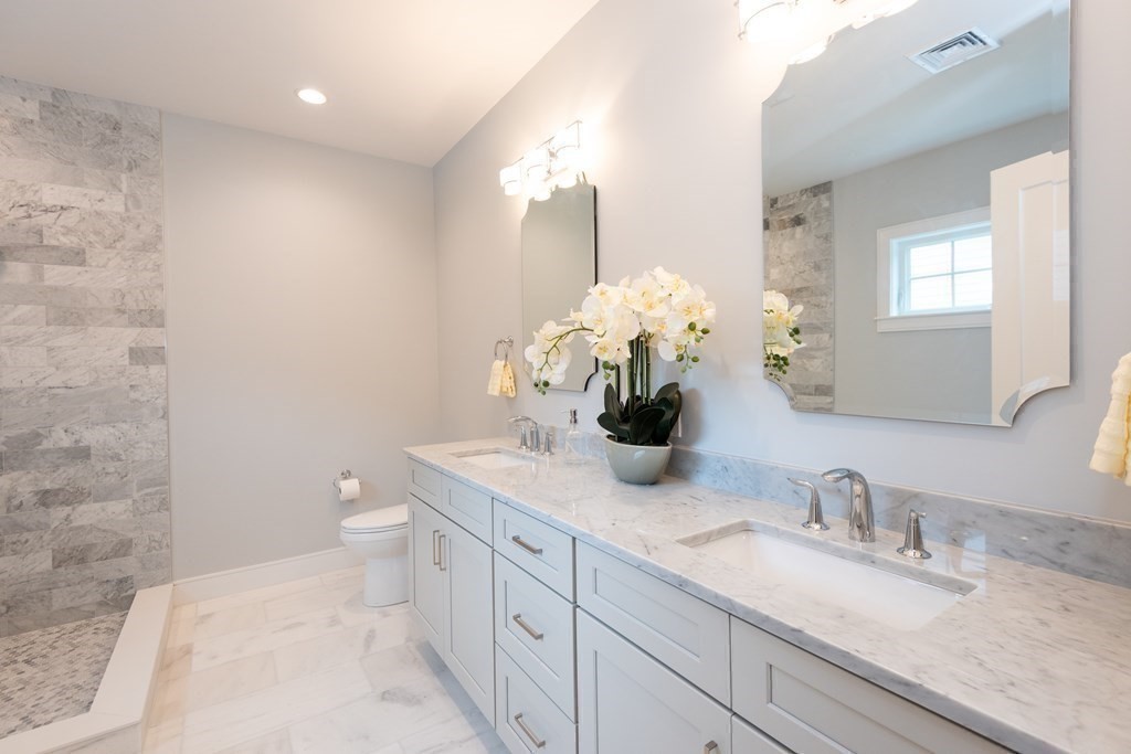 103 Francis Wyman Road Burlington, MA 01803 - Photo 27 of 42 a bathroom with a granite countertop sink and a mirror