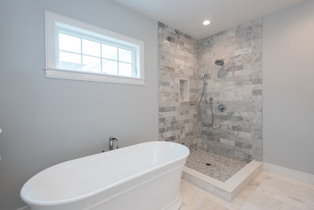 103 Francis Wyman Road Burlington, MA 01803 - Photo 28 of 42 a white bath tub sitting next to a white toilet