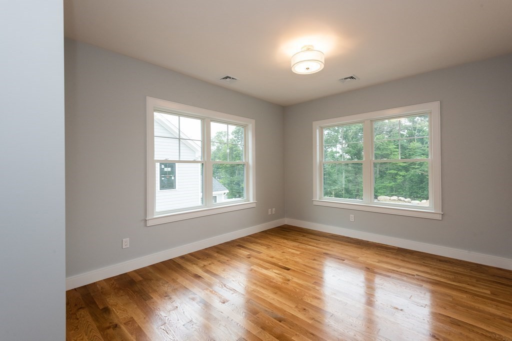 103 Francis Wyman Road Burlington, MA 01803 - Photo 30 of 42 an empty room with wooden floor and windows