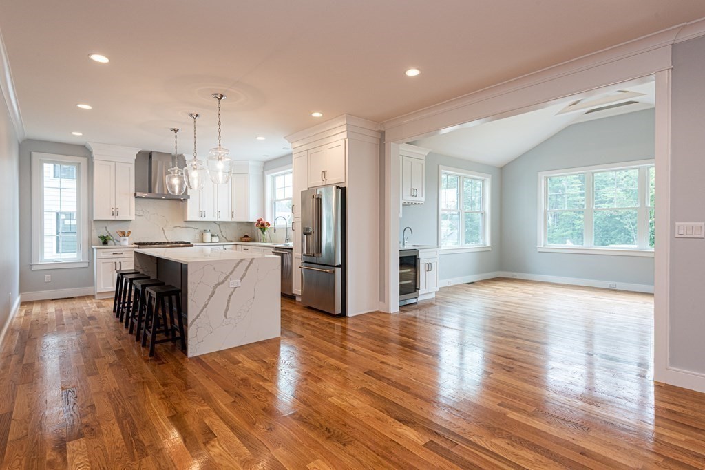 103 Francis Wyman Road Burlington, MA 01803 - Photo 3 of 42 a large kitchen with stainless steel appliances granite countertop a stove a sink dishwasher a refrigerator white cabinets and wooden floor next to a window