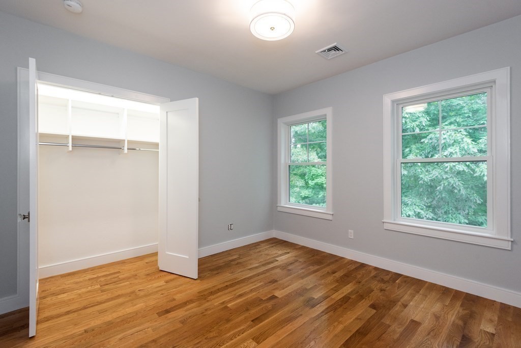 103 Francis Wyman Road Burlington, MA 01803 - Photo 31 of 42 a view of an empty room with wooden floor and a window