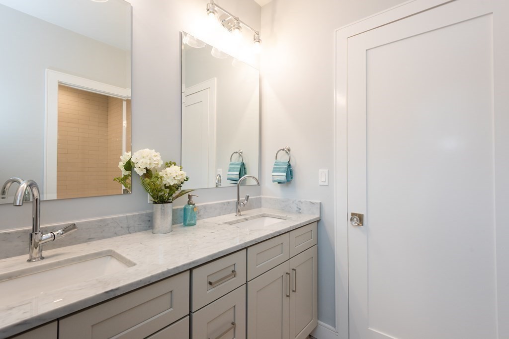 103 Francis Wyman Road Burlington, MA 01803 - Photo 32 of 42 a bathroom with a sink and a mirror