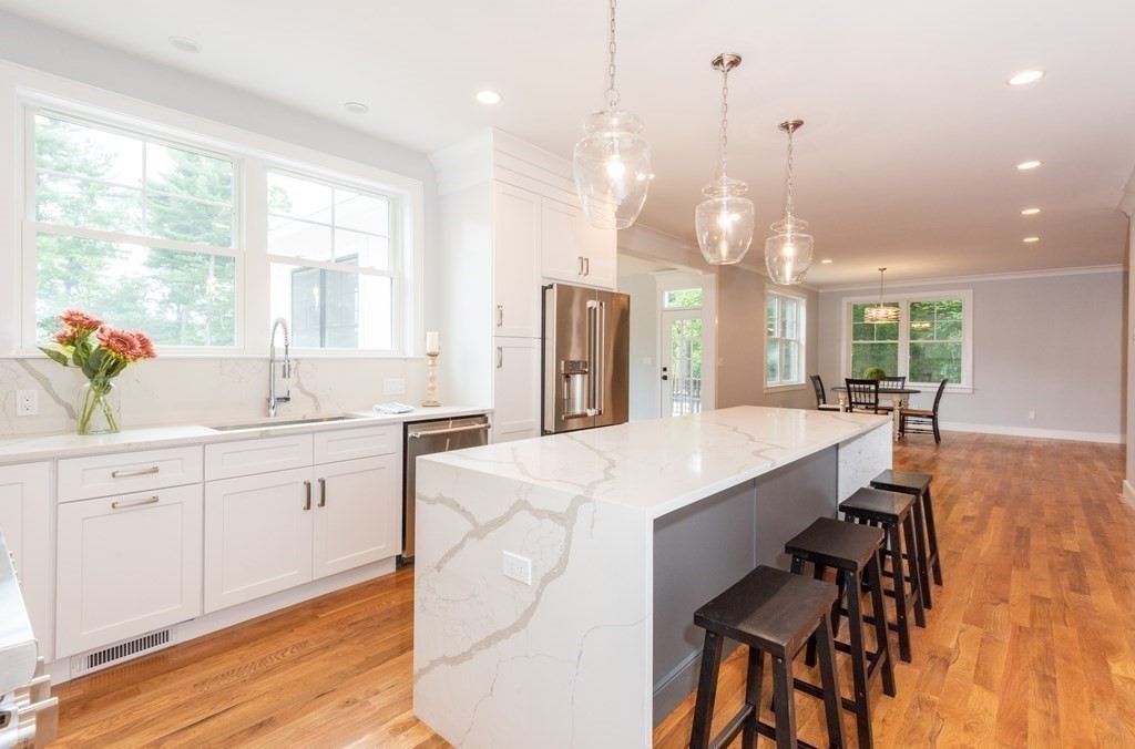 103 Francis Wyman Road Burlington, MA 01803 - Photo 6 of 42 a large kitchen with kitchen island a large island in it