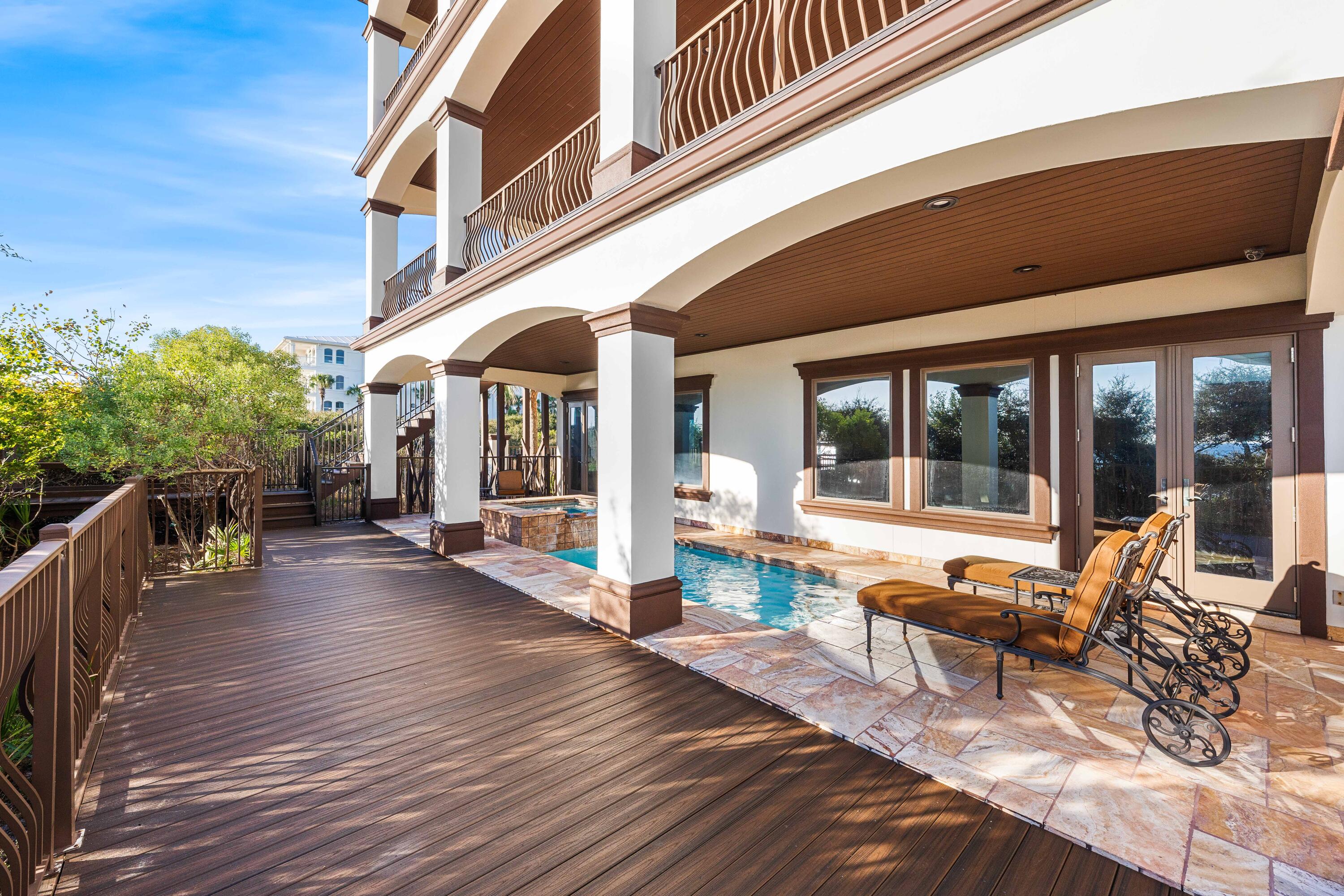 107 Elysee Court Inlet Beach, FL 32461 - Photo 84 of 98 a view of a patio with table and chairs potted plants with wooden floor and fence