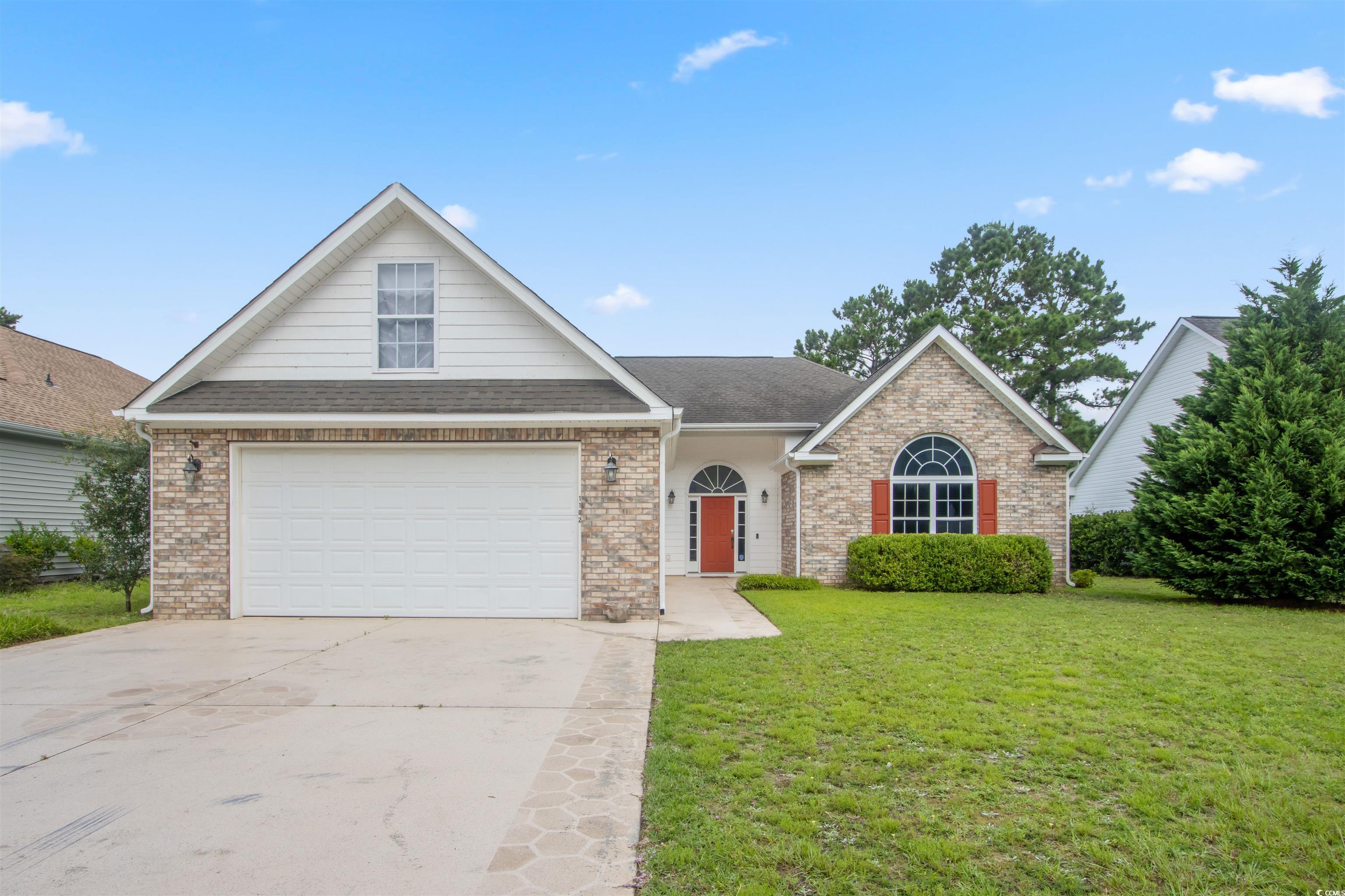 Undisclosed Address Conway, SC 29526 - Photo 1 of 26 Traditional-style home featuring a front lawn, concrete driveway, a garage, brick siding, and roof with shingles