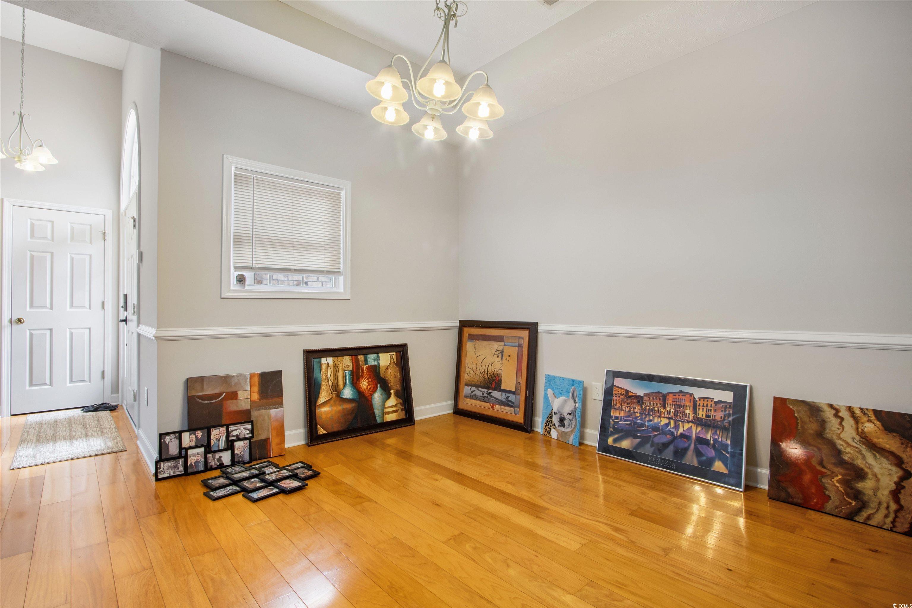 Undisclosed Address Conway, SC 29526 - Photo 20 of 26 Misc room featuring a chandelier and wood finished floors