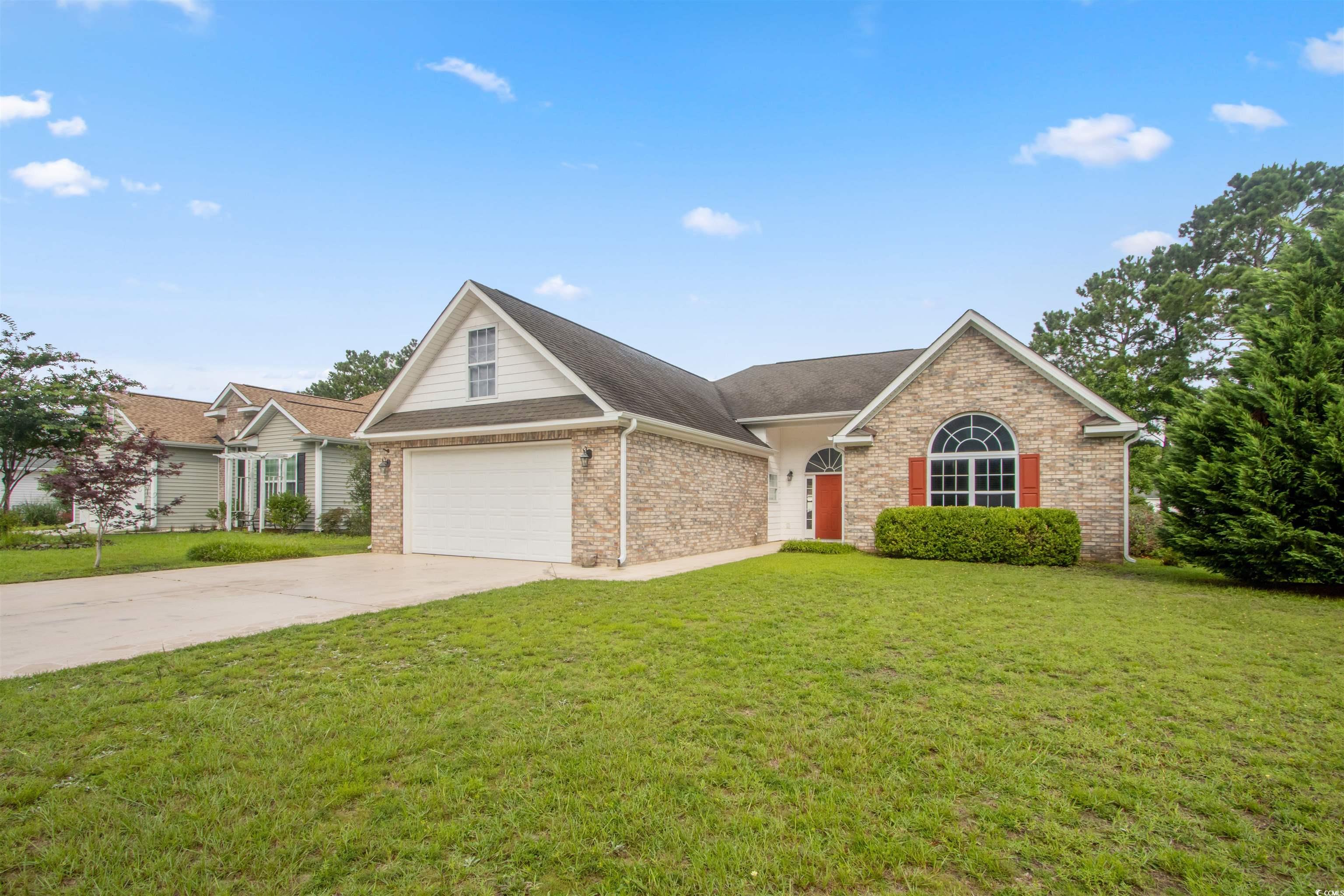 Undisclosed Address Conway, SC 29526 - Photo 2 of 26 View of front of home with driveway, a front lawn, brick siding, a garage, and a shingled roof