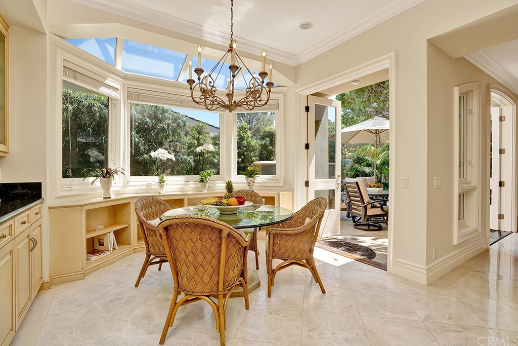 34 Smithcliffs Road Laguna Beach, CA 92651 - Photo 21 of 69 a view of a dining room with furniture a chandelier and large windows