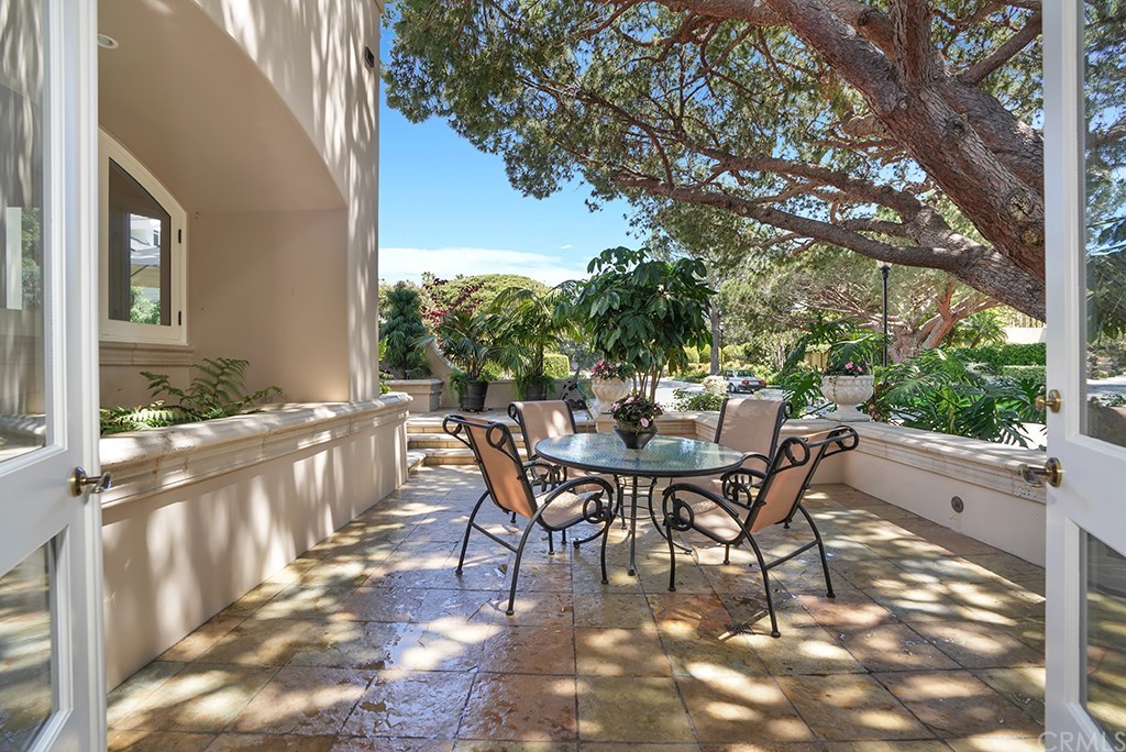 34 Smithcliffs Road Laguna Beach, CA 92651 - Photo 24 of 69 a view of a patio with table and chairs and floor to ceiling window
