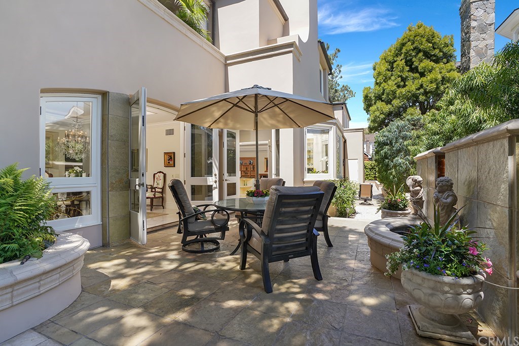 34 Smithcliffs Road Laguna Beach, CA 92651 - Photo 26 of 69 a view of a patio with table and chairs and potted plants