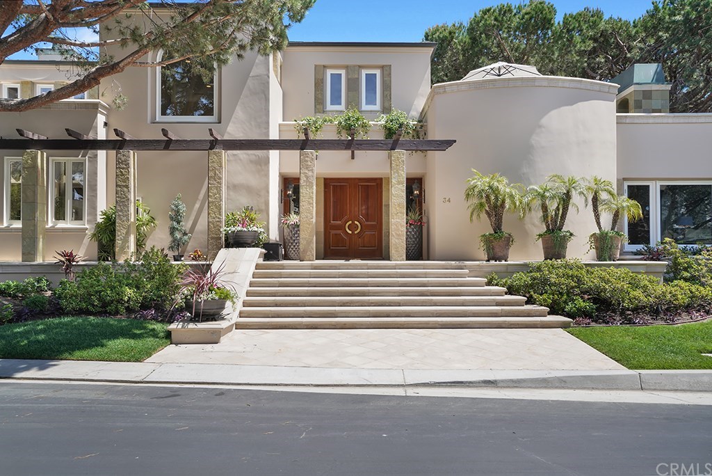 34 Smithcliffs Road Laguna Beach, CA 92651 - Photo 3 of 69 a front view of a house with a garden and plants