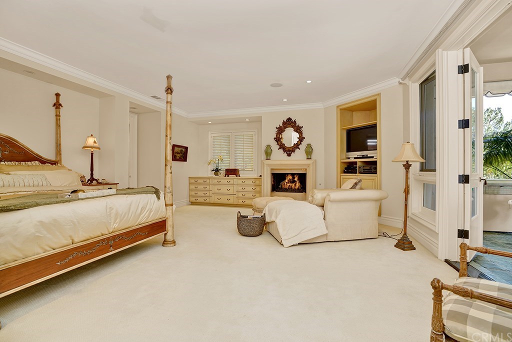 34 Smithcliffs Road Laguna Beach, CA 92651 - Photo 43 of 69 The Master Bedroom is dreamy and elegant. Complete with a Fireplace, TV area and doors to the upstairs Entertaining Deck, and a gorgeous tree, you feel enveloped in a perfect room.