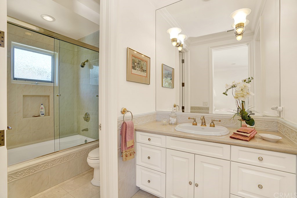34 Smithcliffs Road Laguna Beach, CA 92651 - Photo 60 of 69 a bathroom with a granite countertop sink a toilet a large mirror a bathtub and shower