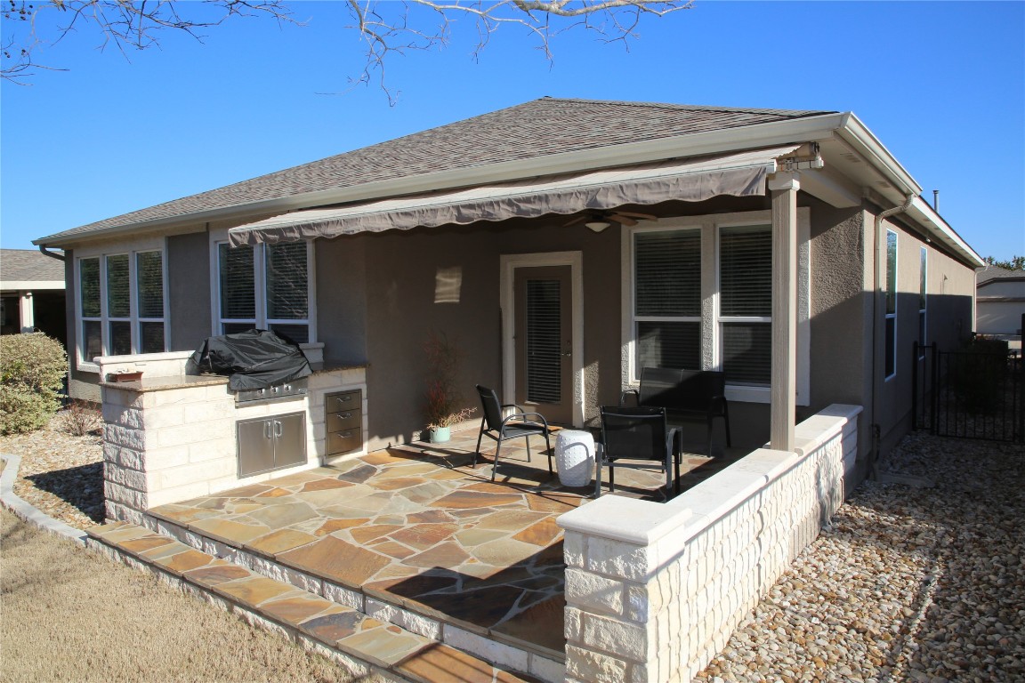 a view of a patio with couches table and chairs with wooden floor