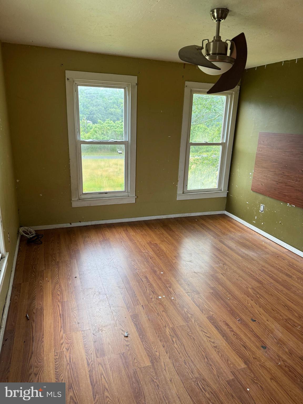 7382 Bullbegger Road Oak Hall, VA 23416 - Photo 13 of 18 an empty room with wooden floor and windows
