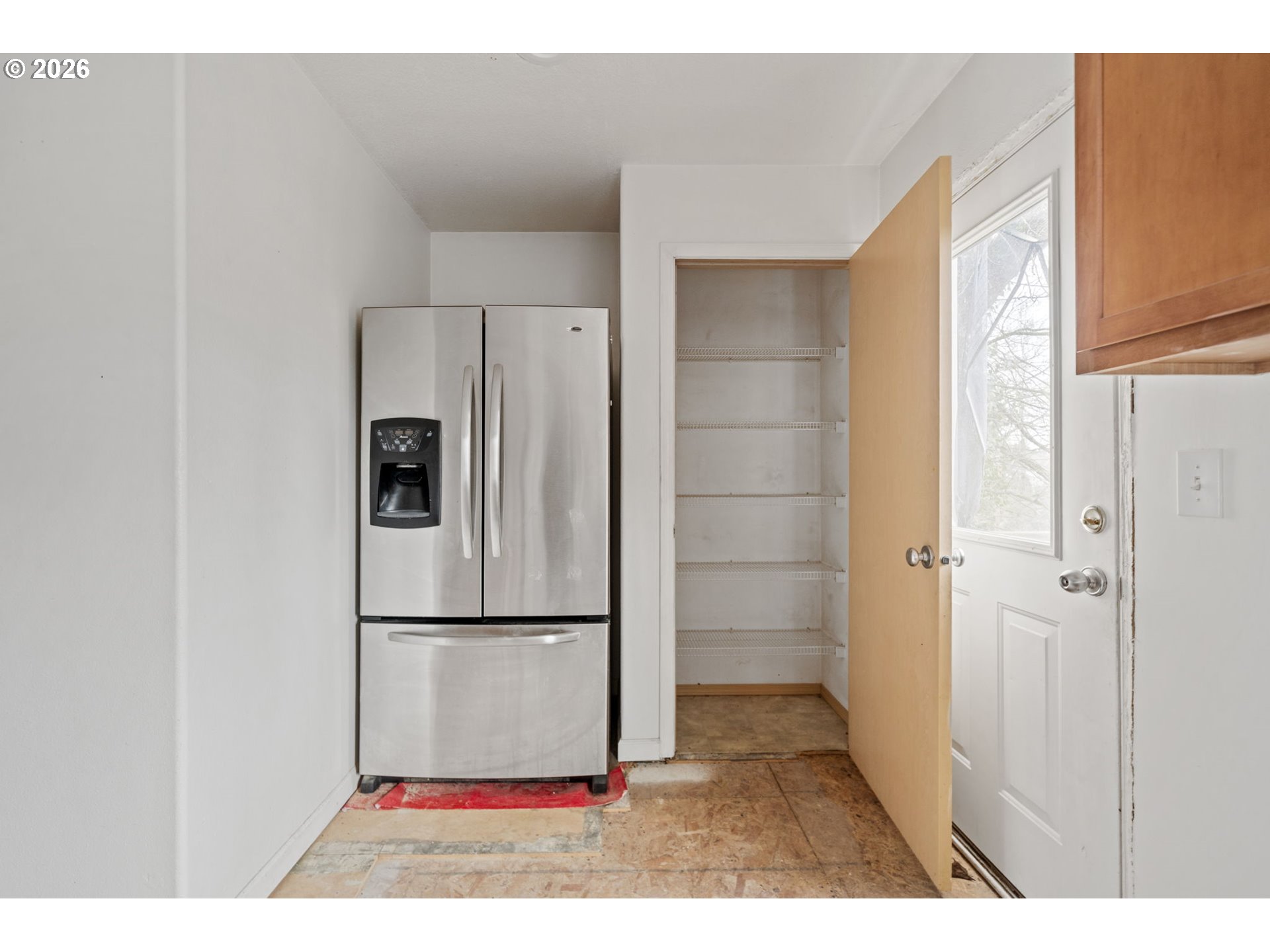 4416 Northeast Nicholson Loop Vancouver, WA 98661 - Photo 13 of 25 a view of a refrigerator in kitchen and an empty room