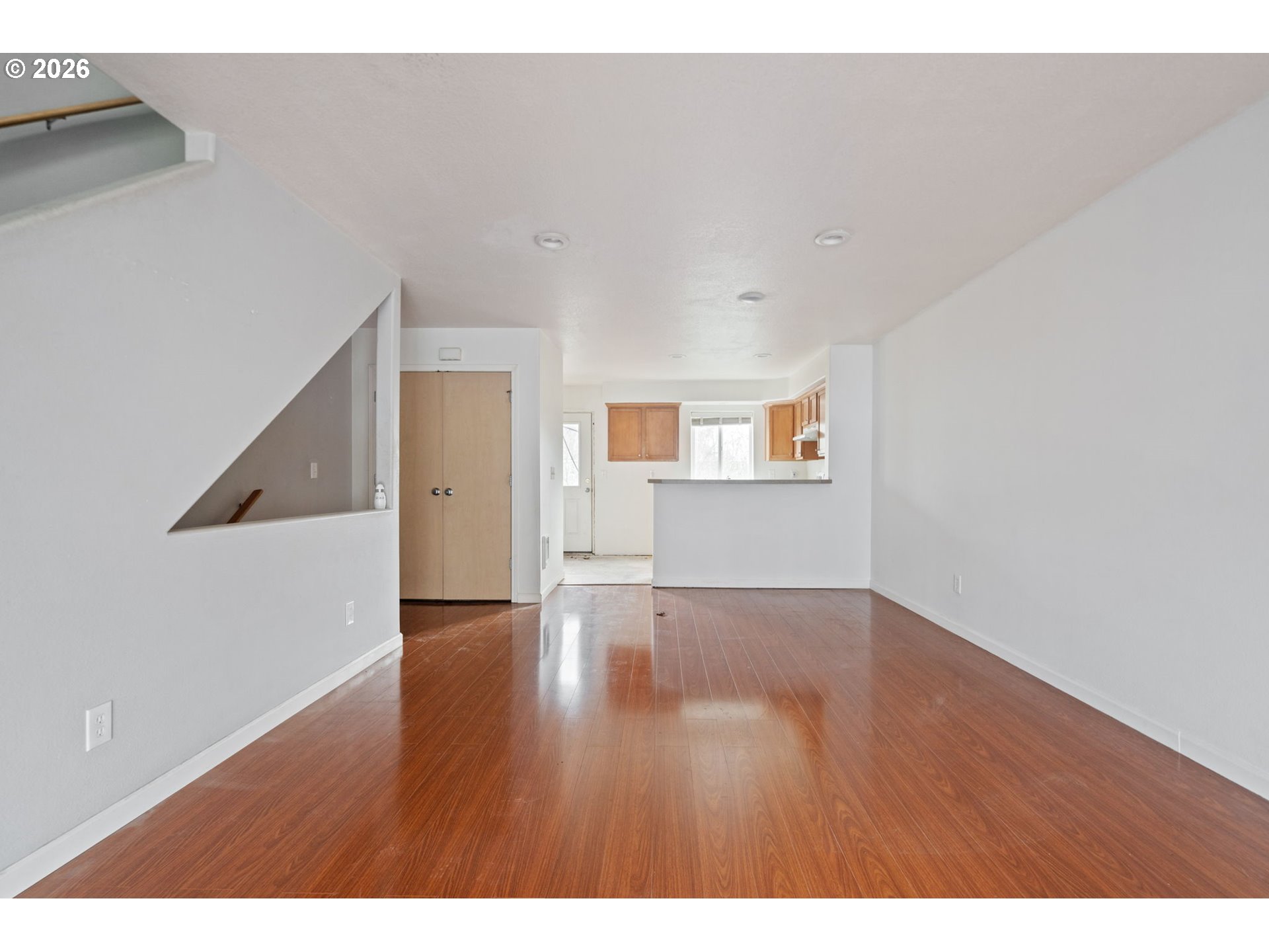 4416 Northeast Nicholson Loop Vancouver, WA 98661 - Photo 7 of 25 a view of an empty room with wooden floor and a window