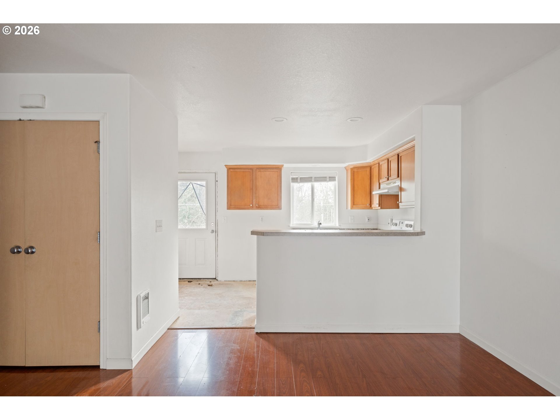 4416 Northeast Nicholson Loop Vancouver, WA 98661 - Photo 9 of 25 a view of an empty room with wooden floor and a window