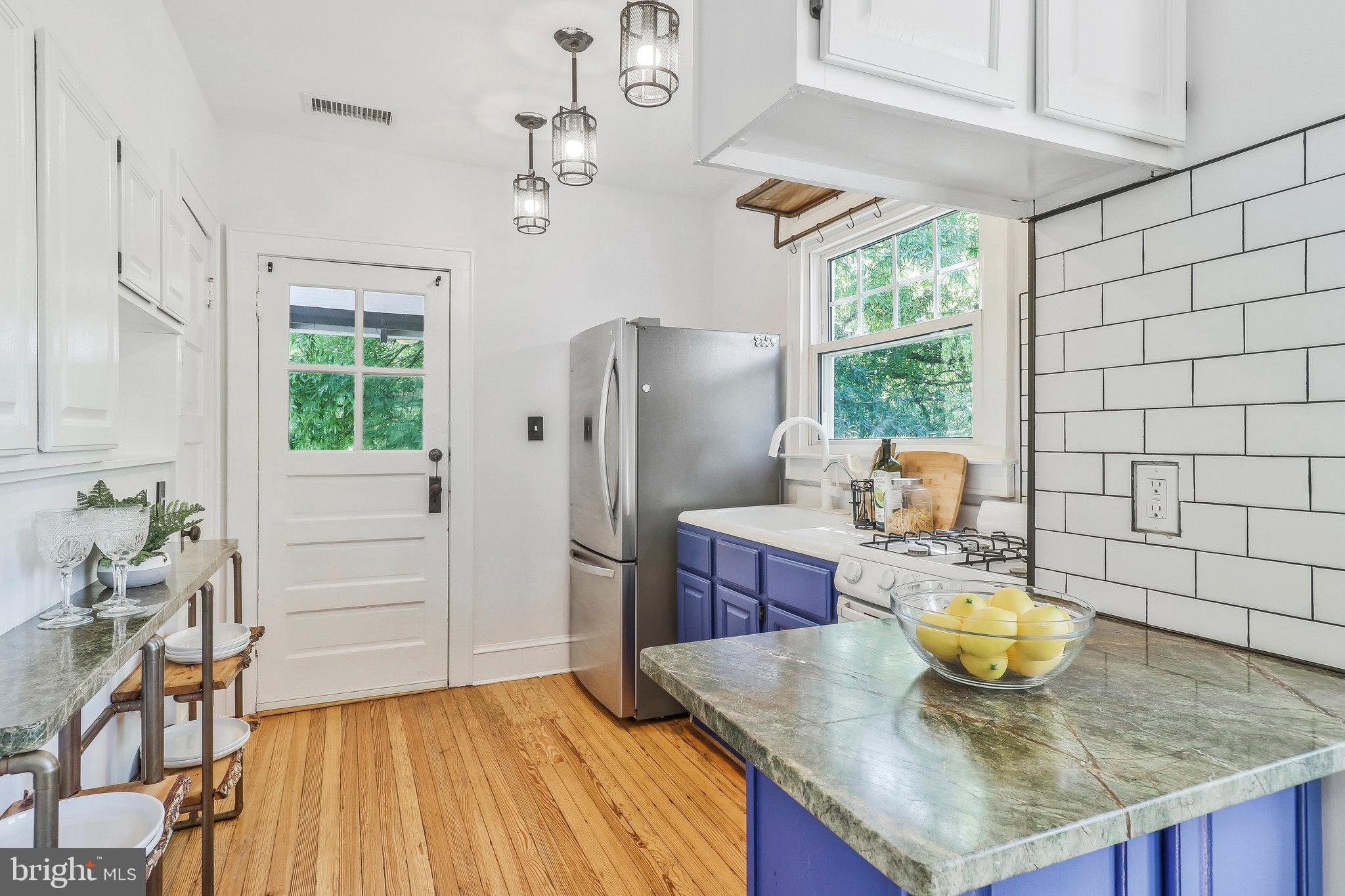 4101 Madison Street Hyattsville, MD 20781 - Photo 9 of 28 Kitchen with pendant light fixtures, subway tile.