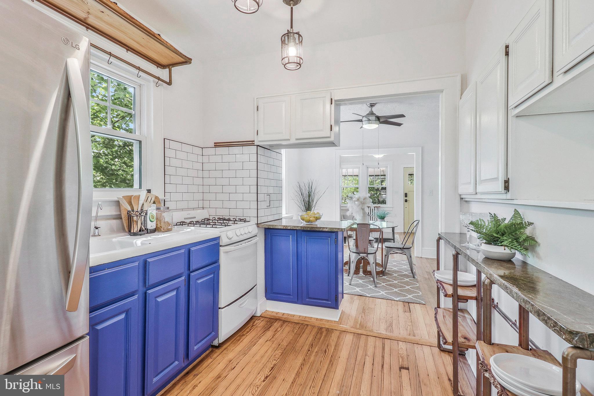 4101 Madison Street Hyattsville, MD 20781 - Photo 10 of 28 Kitchen has open shelves and bright cabinets.