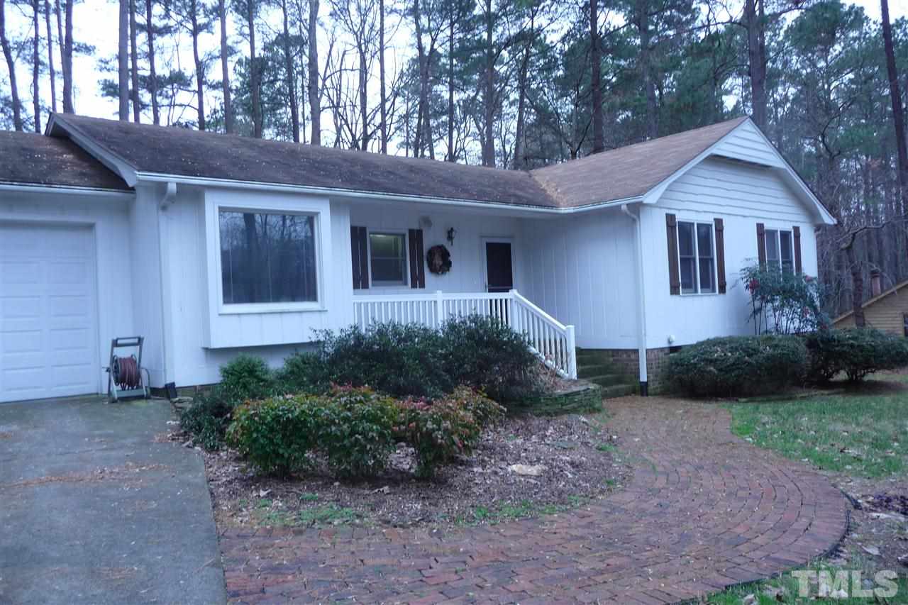 8705 Brandon Station Road Raleigh, NC 27613 - Photo 1 of 16 a front view of a house with garden