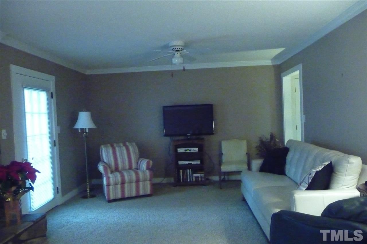 8705 Brandon Station Road Raleigh, NC 27613 - Photo 2 of 16 a living room with furniture and a flat screen tv
