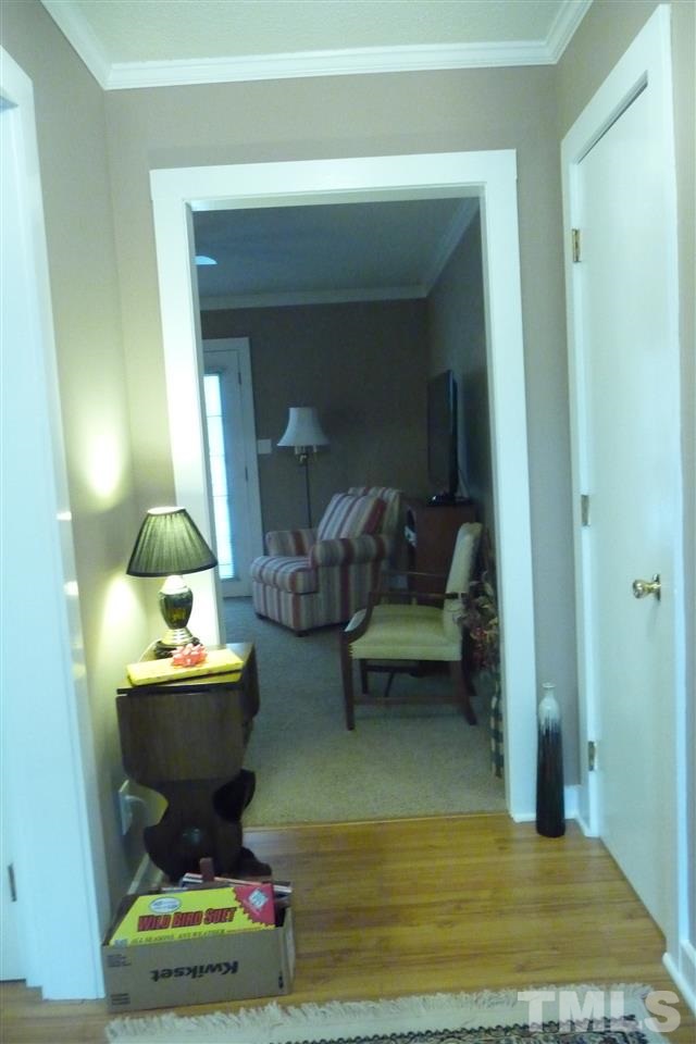 8705 Brandon Station Road Raleigh, NC 27613 - Photo 6 of 16 a living room with furniture and a potted plant