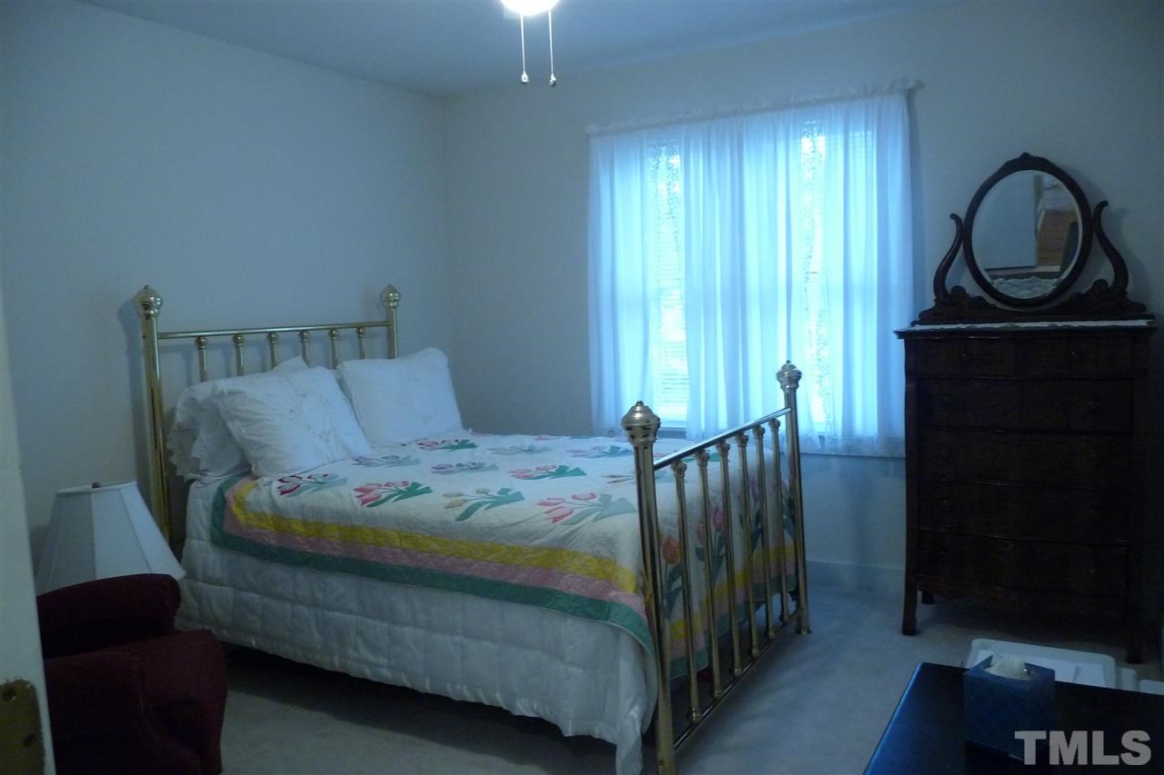 8705 Brandon Station Road Raleigh, NC 27613 - Photo 9 of 16 a bedroom with a bed and a window