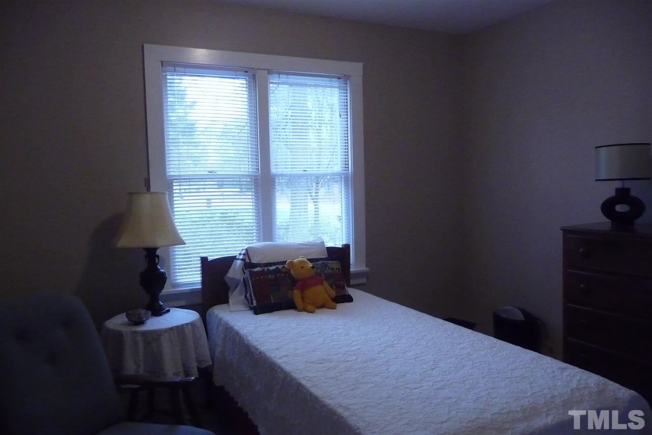 8705 Brandon Station Road Raleigh, NC 27613 - Photo 10 of 16 a bedroom with a bed furniture and window