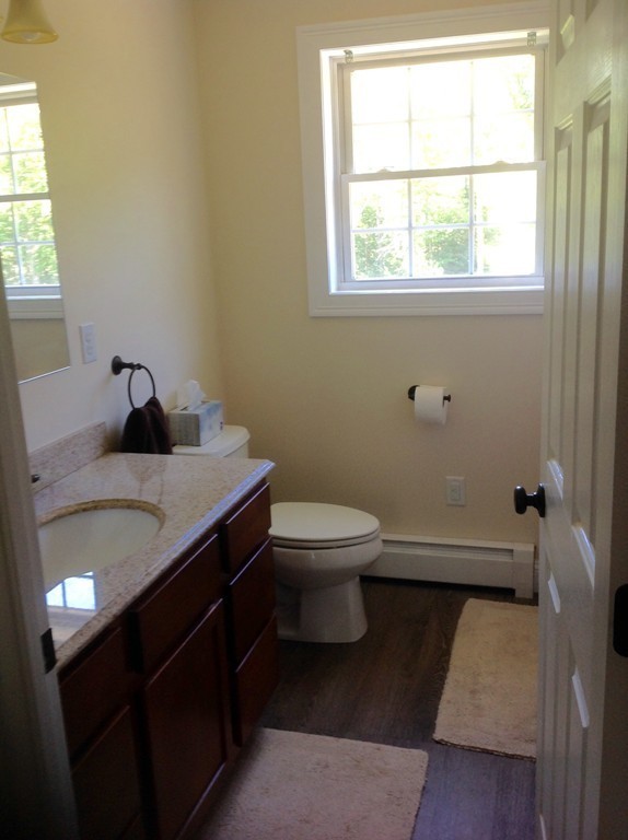 167 Winchendon Road Ashburnham, MA 01430 - Photo 21 of 23 a bathroom with a granite countertop toilet a sink and a window