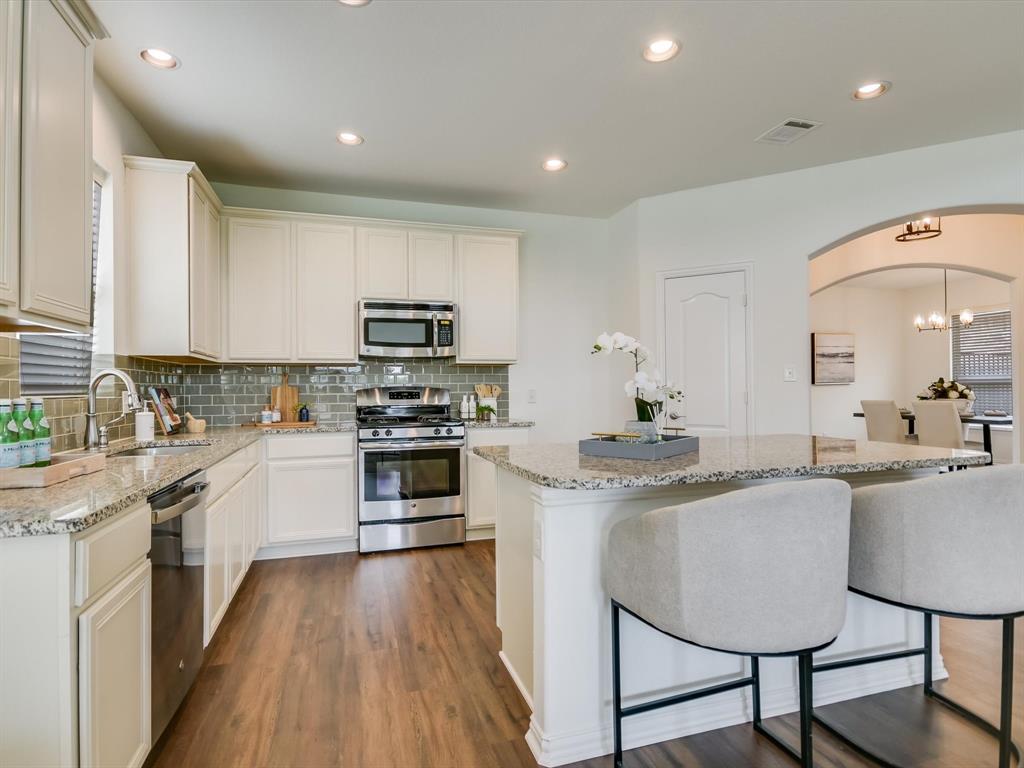 736 Bonnet Boulevard Georgetown, TX 78628 - Photo 7 of 27 a kitchen with kitchen island granite countertop lots of counter top space and appliances