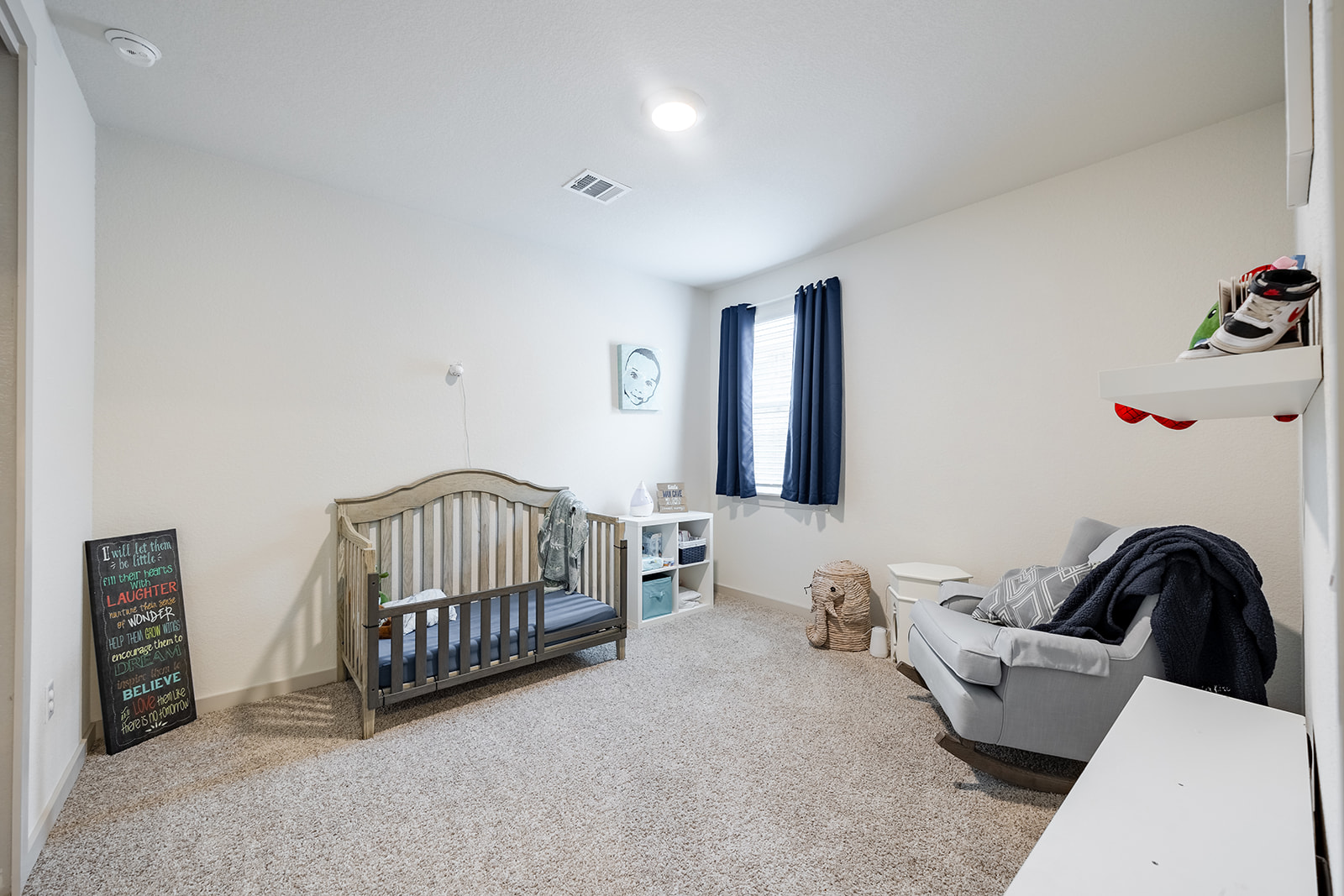 900 Balsora Cove Georgetown, TX 78628 - Photo 16 of 39 A well-lit room with soft carpet and a window for natural light, perfect for a nursery.
