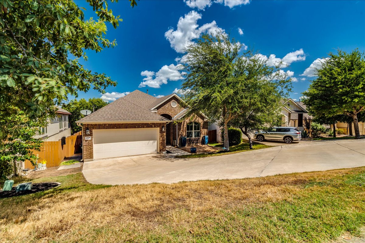 5009 Inks Clearing Lane Austin, TX 78738 - Photo 4 of 34 A classic brick exterior define this single-family home.