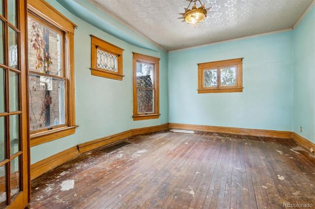 wooden floor in an empty room with a window