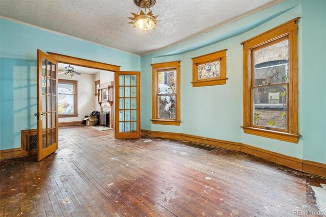 wooden floor in an empty room with a window