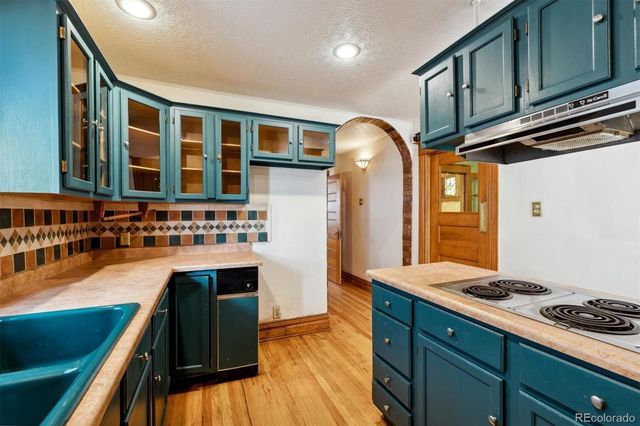 a kitchen with a cabinets and wooden floor