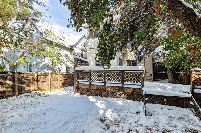 a front view of a house with a yard covered in snow