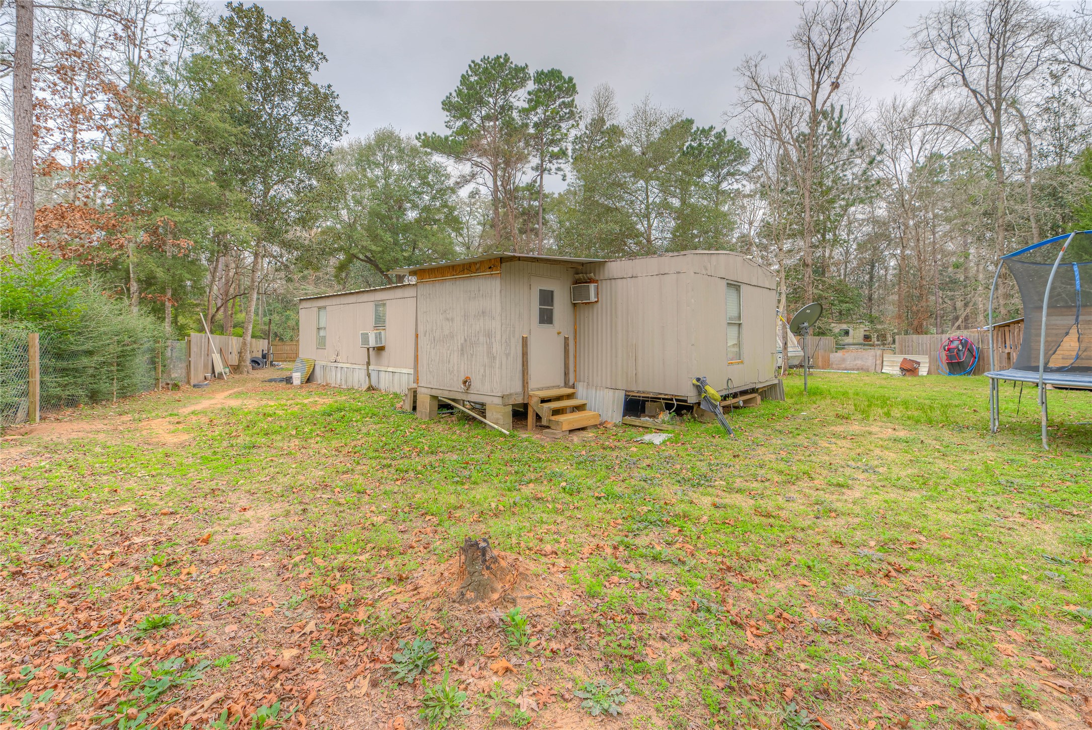 713 Garrett Road Livingston, TX 77351 - Photo 5 of 40 a view of a backyard with large trees and a barn
